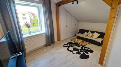 a living room with a couch and a window at Apartament Quiet Street 11, 6E in Oświęcim