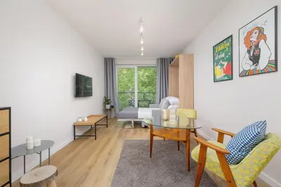 a living room with a table and a dining room at Ap with a balcony- Podgorze- Kalwaryjska 34 in Kraków
