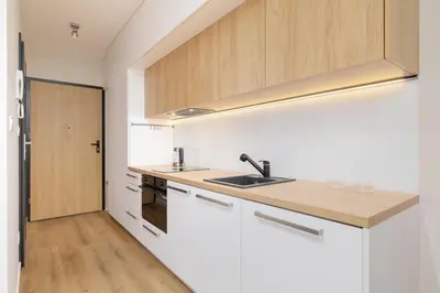 a kitchen with white cabinets and a sink at Ap with a balcony- Podgorze- Kalwaryjska 34 in Kraków