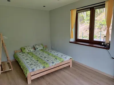 a bedroom with a bed in a room with a window at Apartamenty pod groniem in Sułkowice