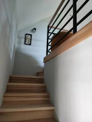 a staircase in a house with wooden stairs at Apartamenty pod groniem in Sułkowice