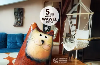 a cat statue in a living room with a sign at A Stone's Throw Apartment in Kraków
