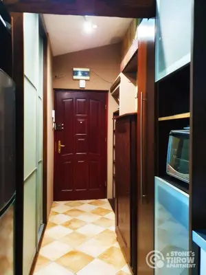 a hallway with a red door and a tiled floor at A Stone's Throw Apartment in Kraków