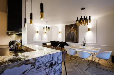 a kitchen and living room with a marble counter top at Mozarta sky terrace VIP 2-bed apartament in Kraków