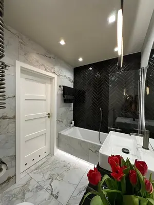 a bathroom with a tub and a white sink and a bath tub at Mozarta sky terrace VIP 2-bed apartament in Kraków