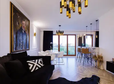 a living room with a couch and a dining room at Mozarta sky terrace VIP 2-bed apartament in Kraków