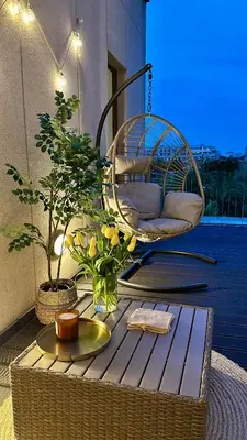 a wicker chair sitting on top of a balcony at Mozarta sky terrace VIP 2-bed apartament in Kraków
