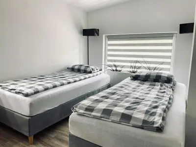 two twin beds in a room with a window at Nocleg blisko Energylandii Zator in Zator