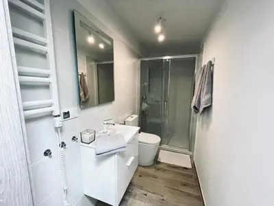a white bathroom with a shower and a sink at Nocleg blisko Energylandii Zator in Zator