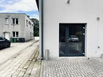 a door to a building with cars in a parking lot at Nocleg blisko Energylandii Zator in Zator