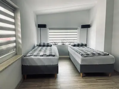 two twin beds in a room with a window at Nocleg blisko Energylandii Zator in Zator