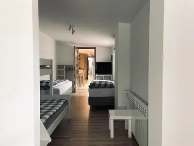 a room with two beds and a hallway at Nocleg blisko Energylandii Zator in Zator