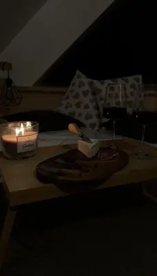 a table with a candle and two glasses of wine at Leśna Przystań Gorce in Nowy Targ