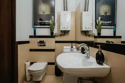 a bathroom with a sink and a toilet at Margarita Panorama Old Town View in Kraków