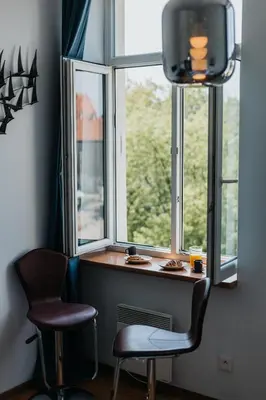 a room with two chairs and a window at Margarita Panorama Old Town View in Kraków