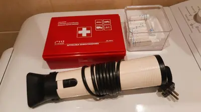 a flashlight on a table next to a red box at Apartament Sofia in Kraków