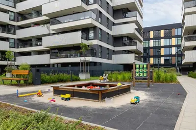 a playground with toys in front of a building at Nowoczesny Apartament z Parkingiem na Alei Pokoju w Krakowie by Noclegi Renters in Kraków