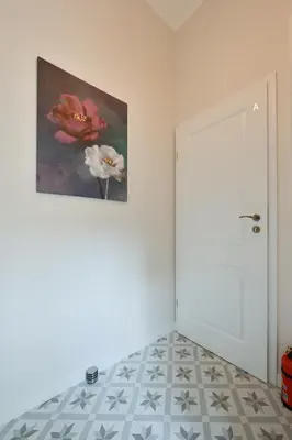 a room with a painting on the wall and a door at RentPlanet - Studio plac Matejki in Kraków
