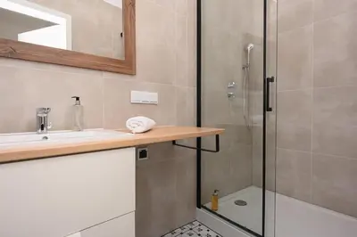 a bathroom with a shower and a sink at RentPlanet - Studio plac Matejki in Kraków