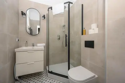 a bathroom with a shower and a toilet and a sink at RentPlanet - Studio plac Matejki in Kraków