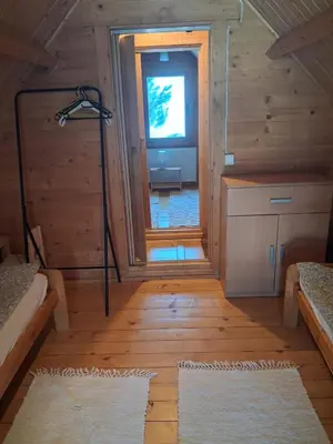a room with a hallway with a window in a cabin at Domek za lasem in Laskowa