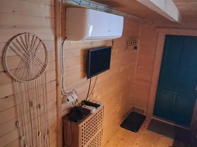an inside view of a room with a television and a fan at Domek za lasem in Laskowa
