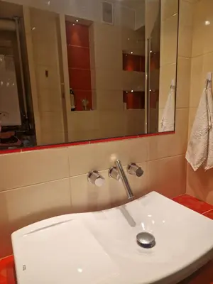 a bathroom with a white sink and a mirror at Słoneczna Skarpa in Rabka-Zdroj