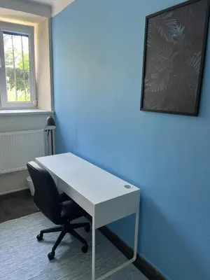 an office with a white desk and a chair at Kasprowicza Rooms in Kraków
