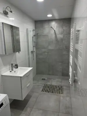 a bathroom with a shower and a sink at Kasprowicza Rooms in Kraków