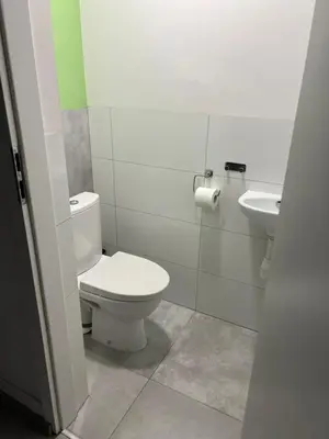 a bathroom with a toilet and a sink at Kasprowicza Rooms in Kraków