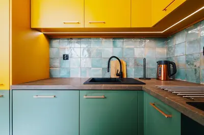 a kitchen with green cabinets and a sink at Jungle Apartment chill&bed Zator in Zator