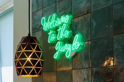 a neon sign on the side of a wall at Jungle Apartment chill&bed Zator in Zator