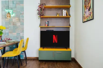 a tv on a stand in a living room with a tv at Jungle Apartment chill&bed Zator in Zator