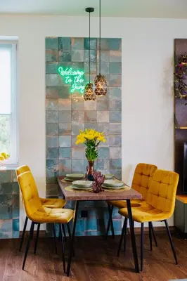 a dining room with a table and yellow chairs at Jungle Apartment chill&bed Zator in Zator