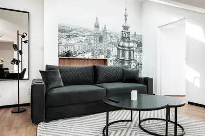 a living room with a couch and a table at Krowoderska 55 - by Upstairs in Kraków