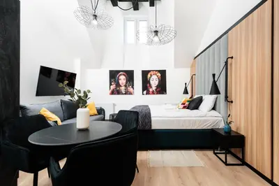 a bedroom with a bed and a table and chairs at Krowoderska 55 - by Upstairs in Kraków