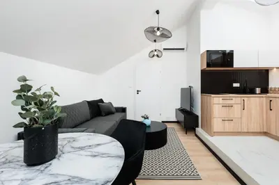 a bedroom with a large bed with a blue blanket at Krowoderska 55 - by Upstairs in Kraków