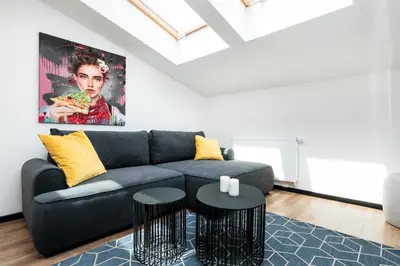 a living room with a couch and a table at Krowoderska 55 - by Upstairs in Kraków