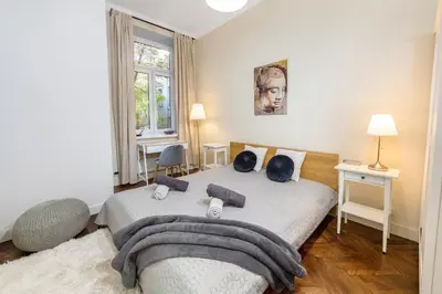 a bedroom with a bed with pillows on it at Apartament Lubomirskiego Centrum Kraków in Kraków