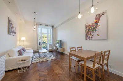 a living room with a table and a dining room at Apartament Lubomirskiego Centrum Kraków in Kraków