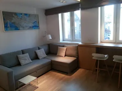 a living room with a couch and some windows at Modern Studio Apartments Old Town-Kazimierz in Kraków