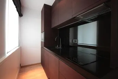 a kitchen with black cabinets and a microwave at Modern Studio Apartments Old Town-Kazimierz in Kraków