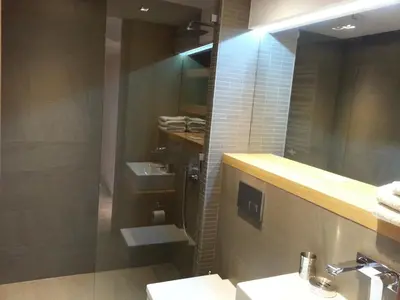 a bathroom with a sink and a shower and a mirror at Modern Studio Apartments Old Town-Kazimierz in Kraków