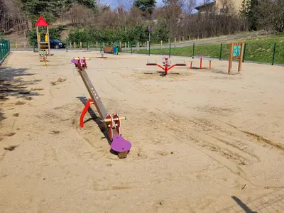 a park with a playground with a slide in the sand at Agroturystyka na Jurze Apartamenty z widokiem na Zamek Jacuzzi Sauna Beczka in Ogrodzieniec