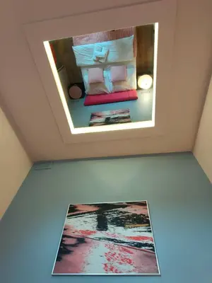 a room with a mirror on the ceiling at Mirror Pink Studio Apartment in Kraków