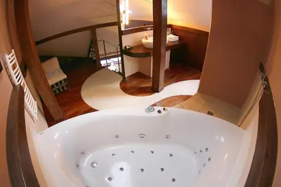 a bath tub in the middle of a bathroom at Krakow Jacuzzi Apartment in Kraków