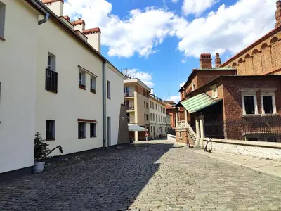 a cobblestone street in a town with buildings at Krakow Jacuzzi Apartment in Kraków
