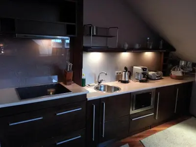 a kitchen with a sink and a counter top at Krakow Jacuzzi Apartment in Kraków