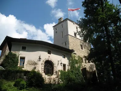 a castle with a flag on top of it at Zamek Korzkiew in Korzkiew