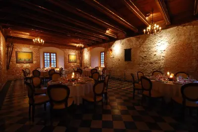 a room with tables and chairs in a building at Zamek Korzkiew in Korzkiew
